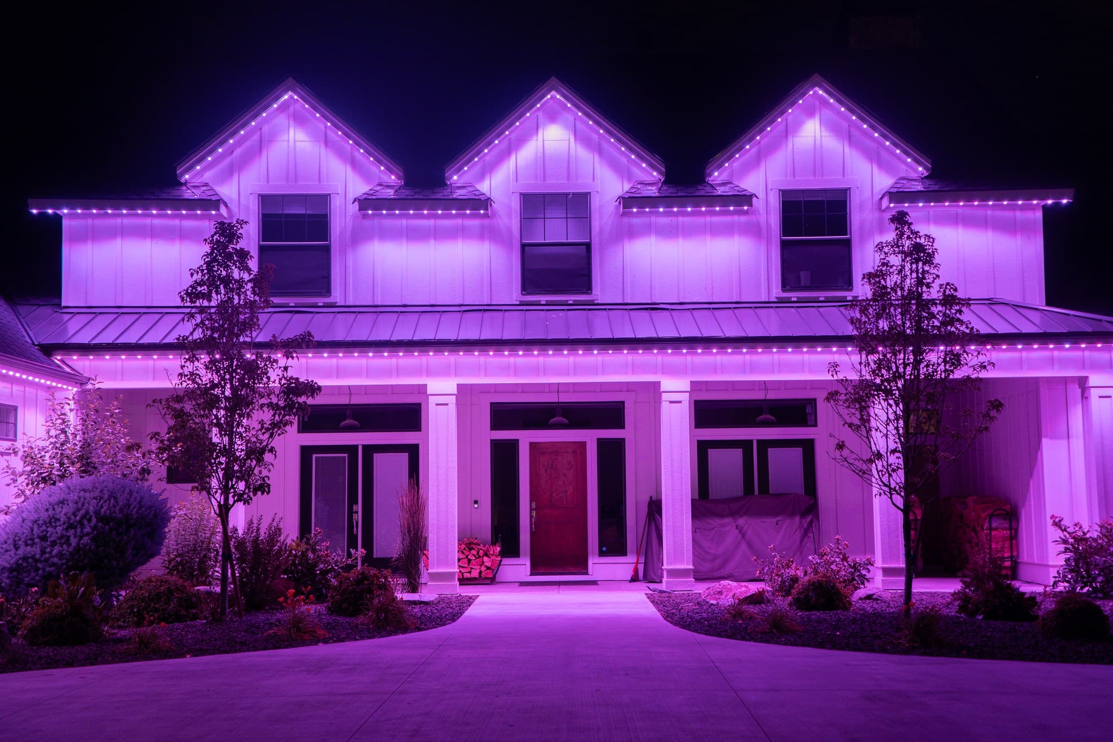Owner-supplied Bosso lighting installation with colorful roofline lights on a residential exterior